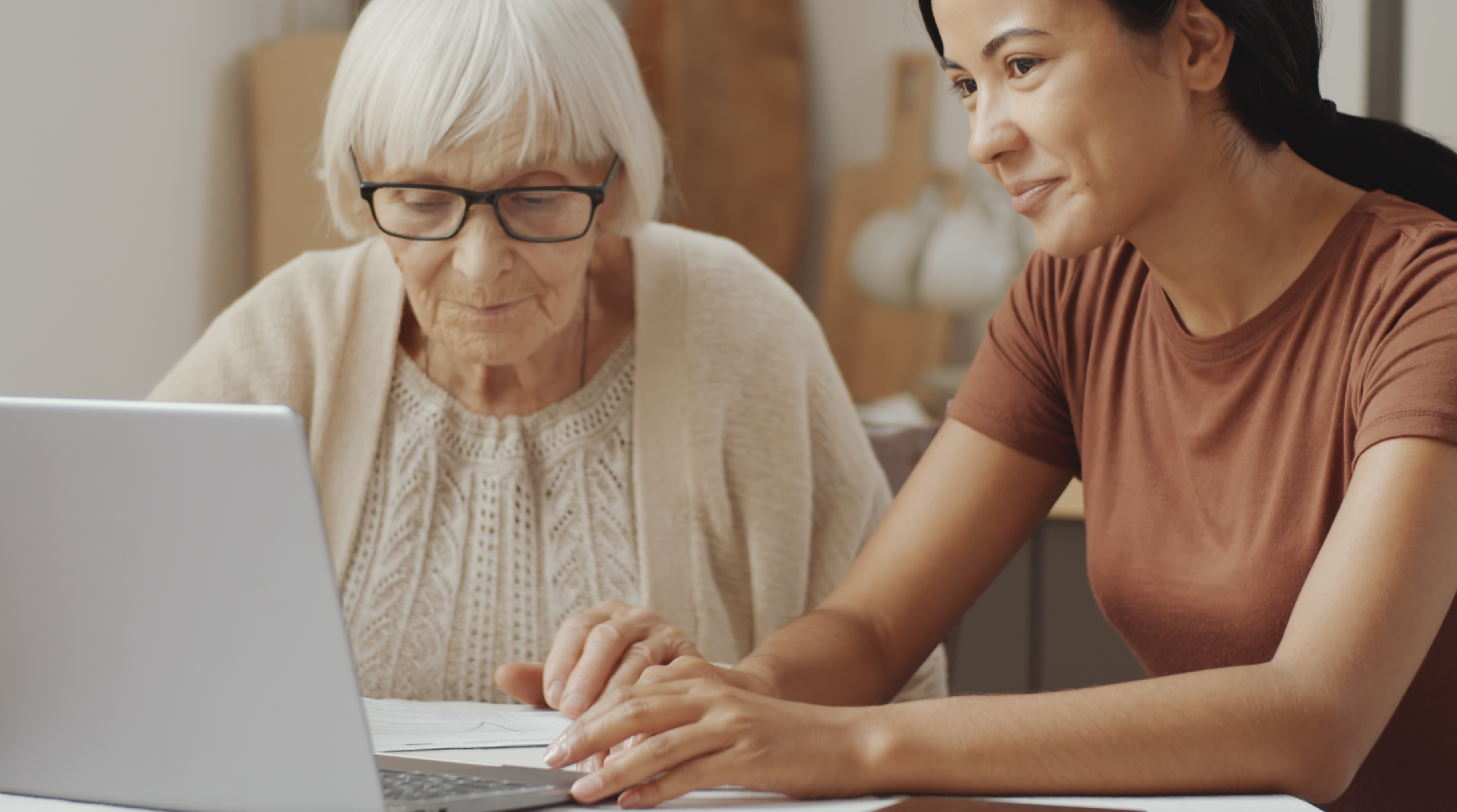 Helping Senior on laptop
