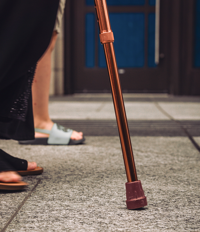 Senior's cane on pavement - Near U and Me